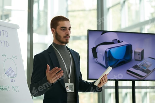 Preview: Young confident businessman in formalwear explaining something to audience
