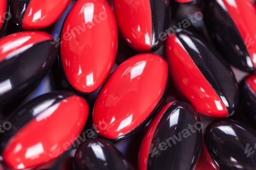 Preview: a scattering of red-black brown pills on the mirror background