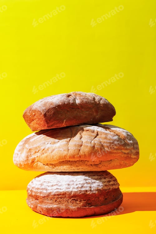 Preview: Stacked Sourdough Bread on Yellow Surface