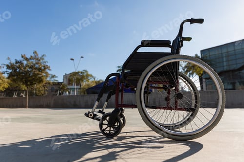 Preview: Wheelchair parked outdoors in a park at daytime.