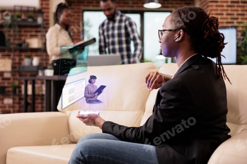 Preview: Female employee talking to ai hologram