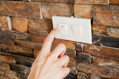 Preview: Human finger turning off the light switch - green earth and energy saving concept