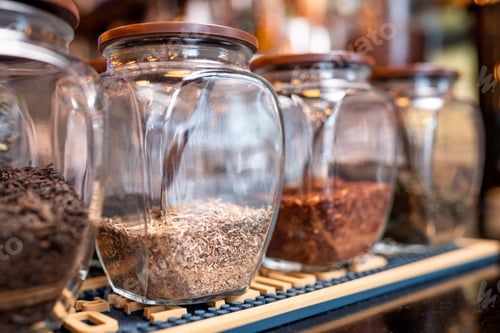 Preview: Row of big jars with fresh black, white, green and rooibos tea assortment