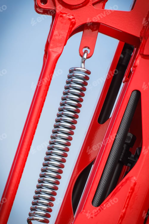 Preview: Hard spring made of steel on blue sky background