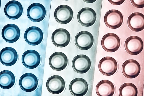 Preview: Tablets and capsules pill in blister packaging arranged in row. Medicines - tablets, pills