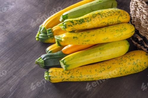 Preview: Yellow-green leopard-spotted zucchini. Vegetables on the table. Zucchini harvest.