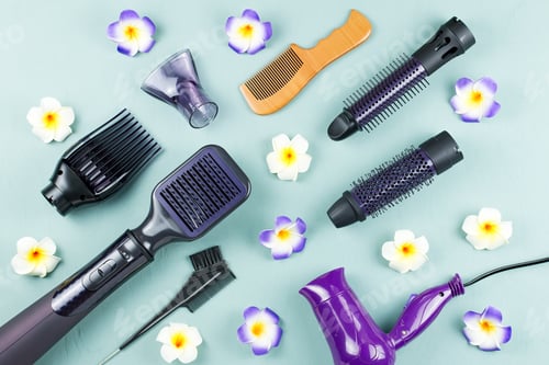 Preview: Hairdressing tools with flowers on blue wooden background