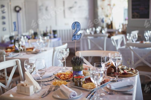 Preview: Dining table setting at Provence style, with candles, lavender, vintage crockery and cutlery.
