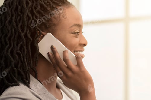 Preview: Smiling Afro Businesswoman Talking On Cellphone Standing In Office, Closeup