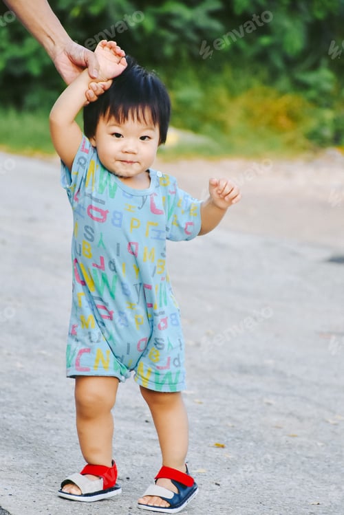 Preview: first steps of little boy in summer park