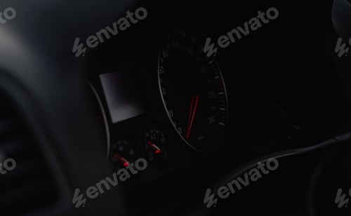 Preview: High angle shot of a modern car speedometer with a red arrow
