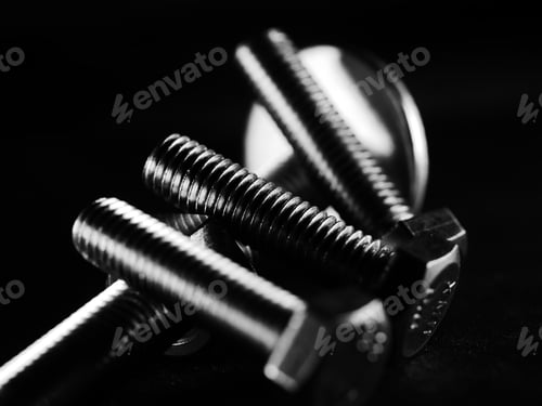 Preview: Studio grayscale of screws on black background