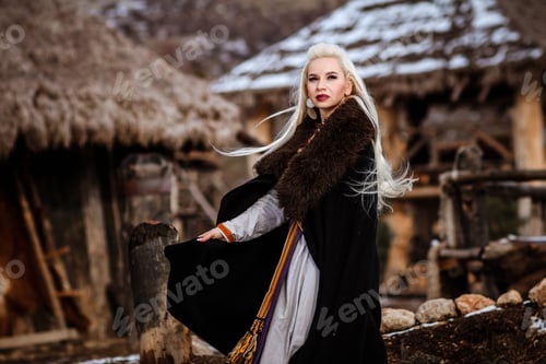 Preview: Beautiful young woman holding a viking with blond hair. Image of Historical figure