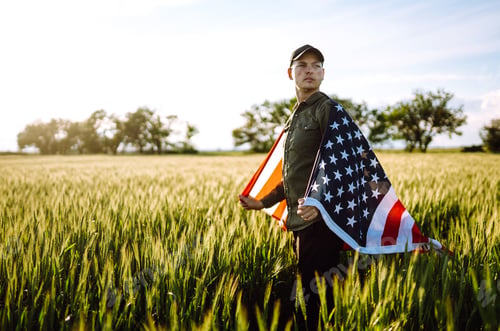 Preview: Man hold waving american USA flag. Patriot raise national american flag. Independence Day, 4th July.