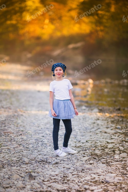 Preview: The portrait of blonde girl with two braids. Autumn in the yellow forest