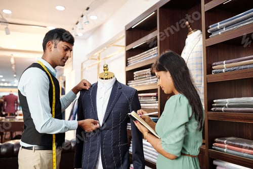 Preview: Tailors Fitting Bespoke Suit in Fashionable Urban Shop
