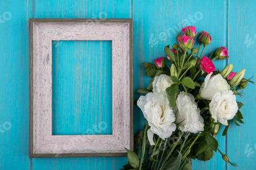 Preview: top view of lovely white and pink roses with leaves on a blue background with copy space