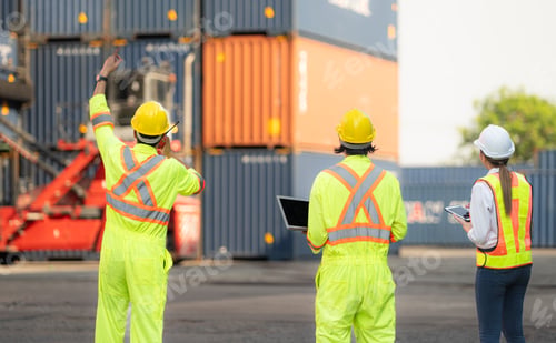 Preview: Group of workers in the import and export industry use walkie talkies to communicate