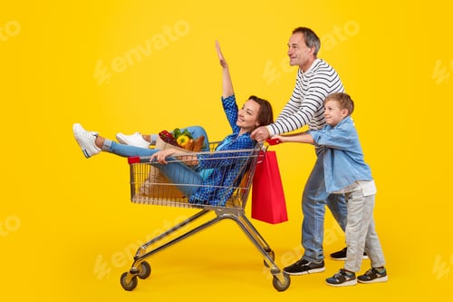 Preview: Father and son pushing shopping cart with mother