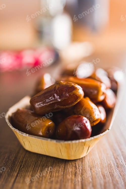 Preview: Dried dates fruit on wooden table.