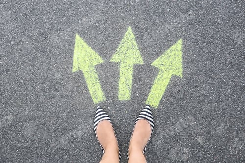Preview: Woman standing on road near arrows marking, closeup