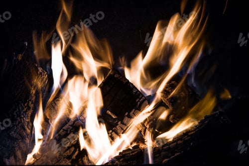 Preview: Fire orange tongues on black background in a brick fireplace