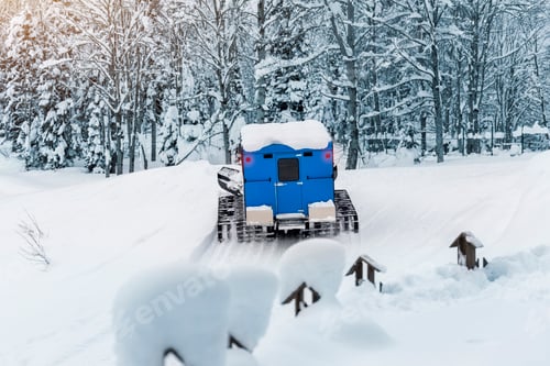 Preview: Rear back door window view blue modern snowcat ratrack grooming machine with cabine box preparing