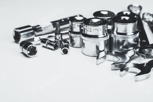 Preview: Assorted metal tools arranged on a white background for repair and maintenance tasks in a workshop