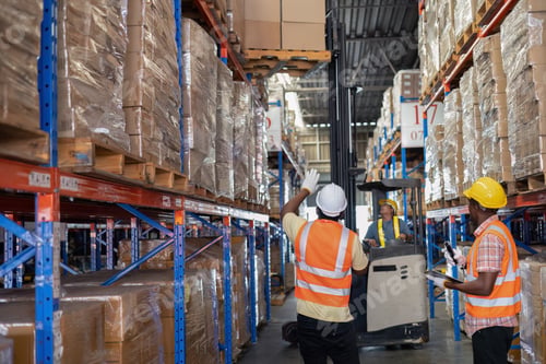 Preview: Worker in depot storage warehouse use tablet pc check scan barcode goods box and store on shelf