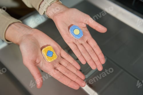 Preview: Dishwasher detergent tablets comparison in hands near open dishwasher