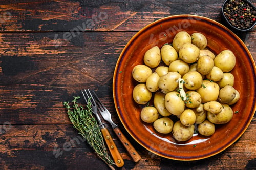 Preview: New young boiled potato with butter and chopped dill. Dark Wooden background. Top view. Copy space