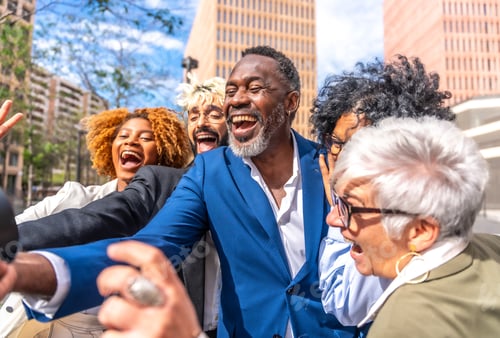 Preview: Happy mature african businessman taking a selfie with colleagues outdoors