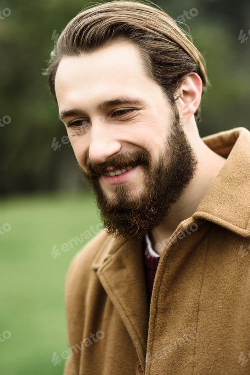Preview: smiling man in a brown coat