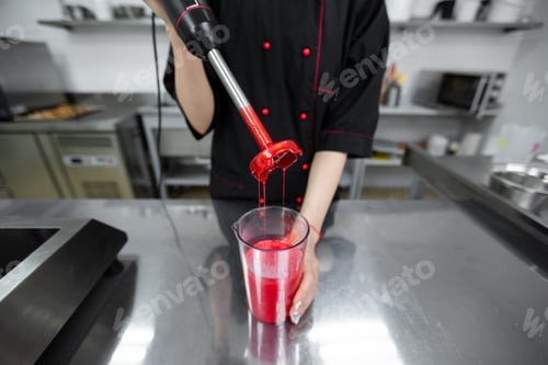 Preview: Pastry chef whips up the red mirror icing for the cake with a blender