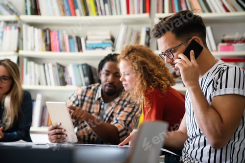 Preview: Group of young multi-ethnic startup business team collaborating on project in modern office