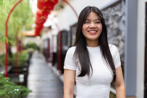 Preview: Portrait of beautiful Asian woman outdoors in Chinese style garden