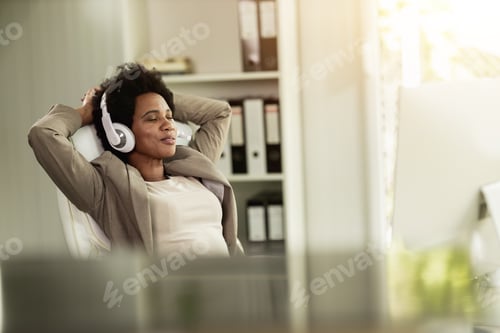 Preview: Black Woman With Headphones Feeling Accomplished And Enjoying A Break At The Office