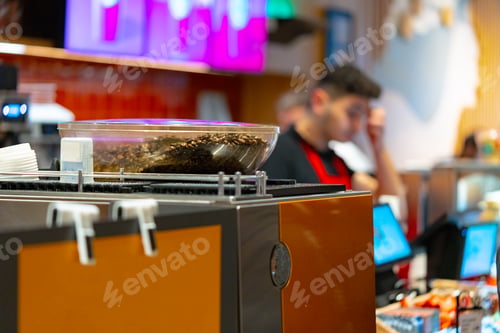 Preview: Coffee beans in a coffee machine in coffeeshop