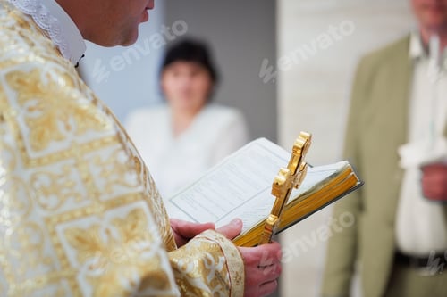 Preview: Beautiful golden cross in male hands of priest