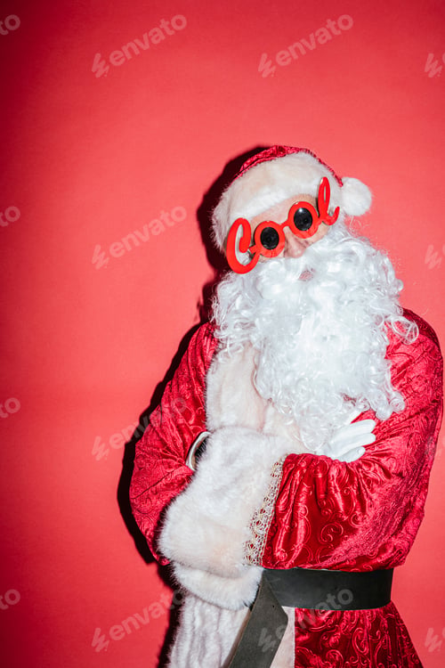 Preview: Man dressed as Santa Claus gesturing with funny glasses