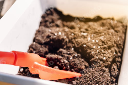 Preview: box with gardening sand and a red shovel