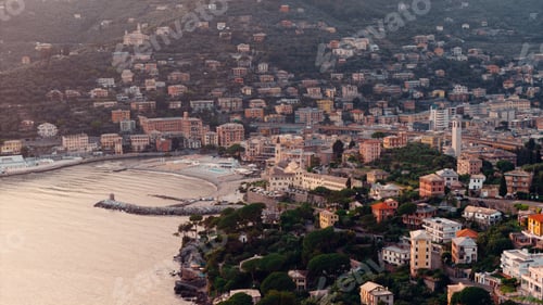 Preview: Camogli, liguria, italy: colorful buildings covering the hillside at sunset