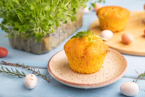 Preview: Homemade cakes with chocolate eggs and microgreen on a blue, side view, selective focus.