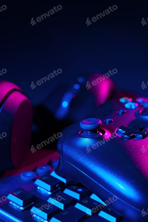 Preview: Headphones, joystick and computer keyboard on black table