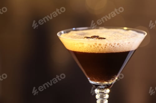 Preview: Glass of delicious Espresso Martini on blurred background. Alcohol cocktail
