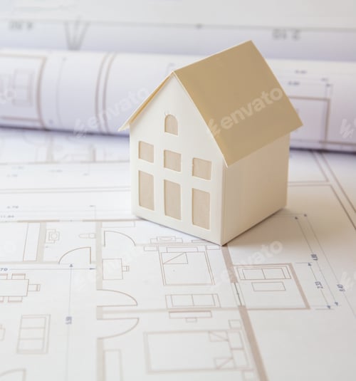 Preview: Construction concept. Residential building drawings and architectural house model on an office desk