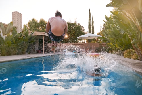 Preview: Women Outdoors Relaxing At Summer Pool Party Watching Men Dive Into Water