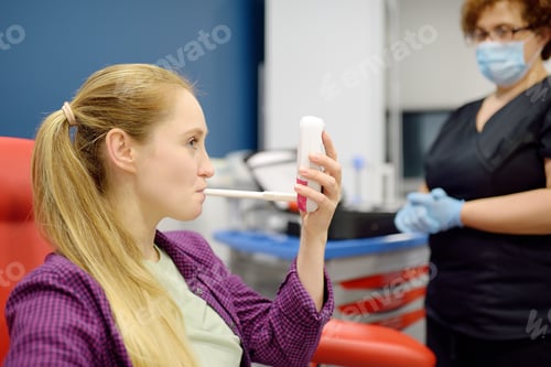 Preview: nurse in the laboratory offers the patient a balloon for blowing to perform a test for Helicobacter