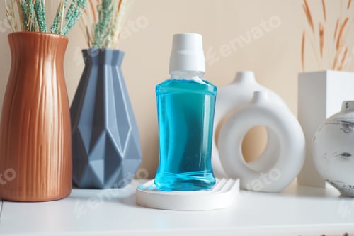 Preview: mouthwash liquid in a container on table