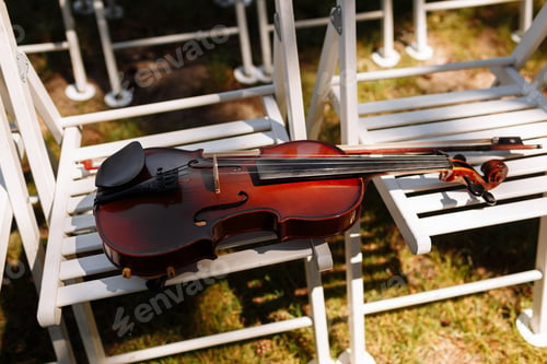 Preview: Beautiful violin on a white chair. selective focus.
